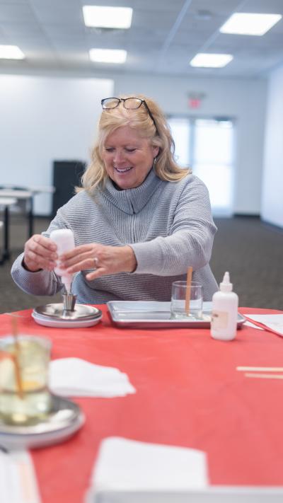 A woman making her own candle