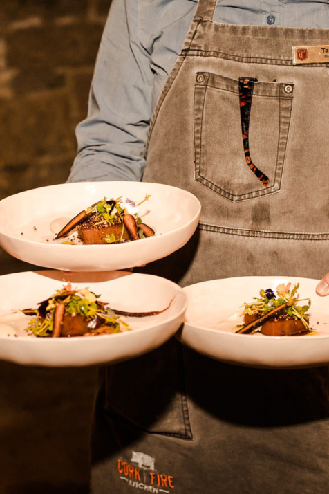 Server caring three dishes of food