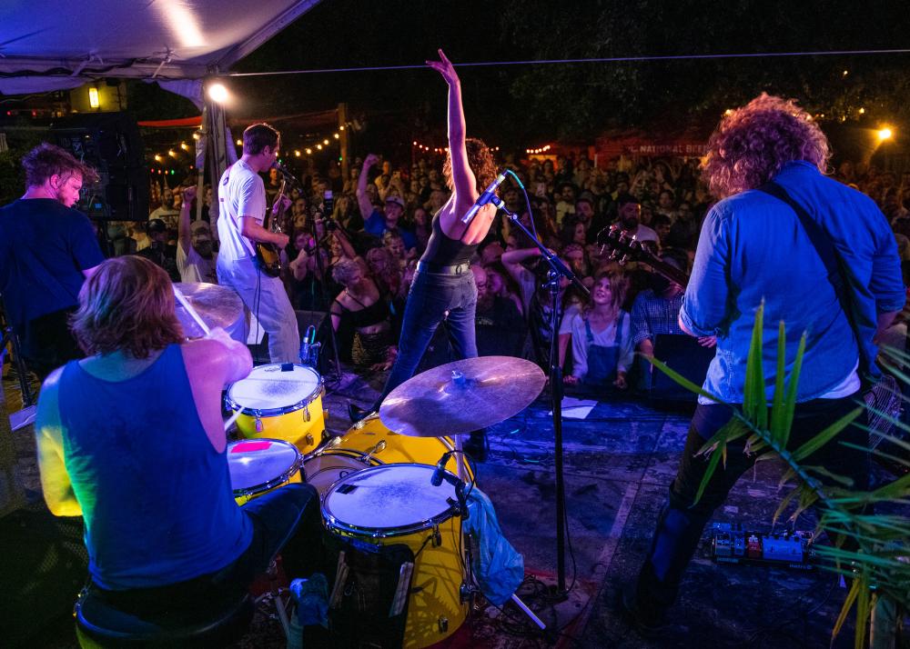 View of band playing on stage with huge crowd in the background at Hotel Vegas.