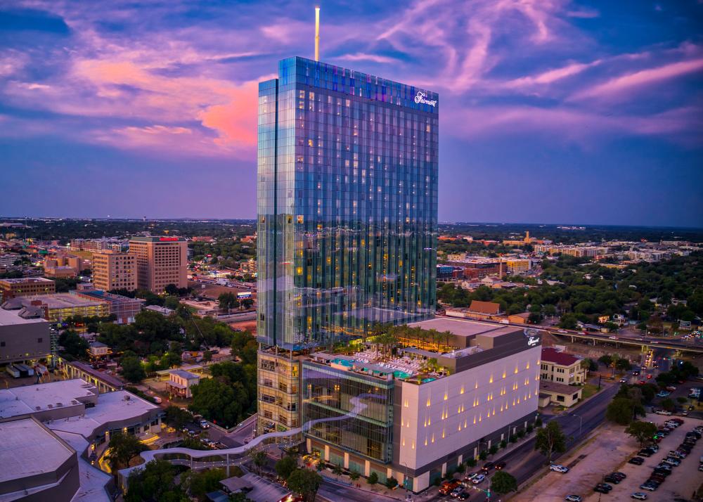 Exterior at sunset with skybridge and rooftop pool at the Fairmont hotel in Austin Texas