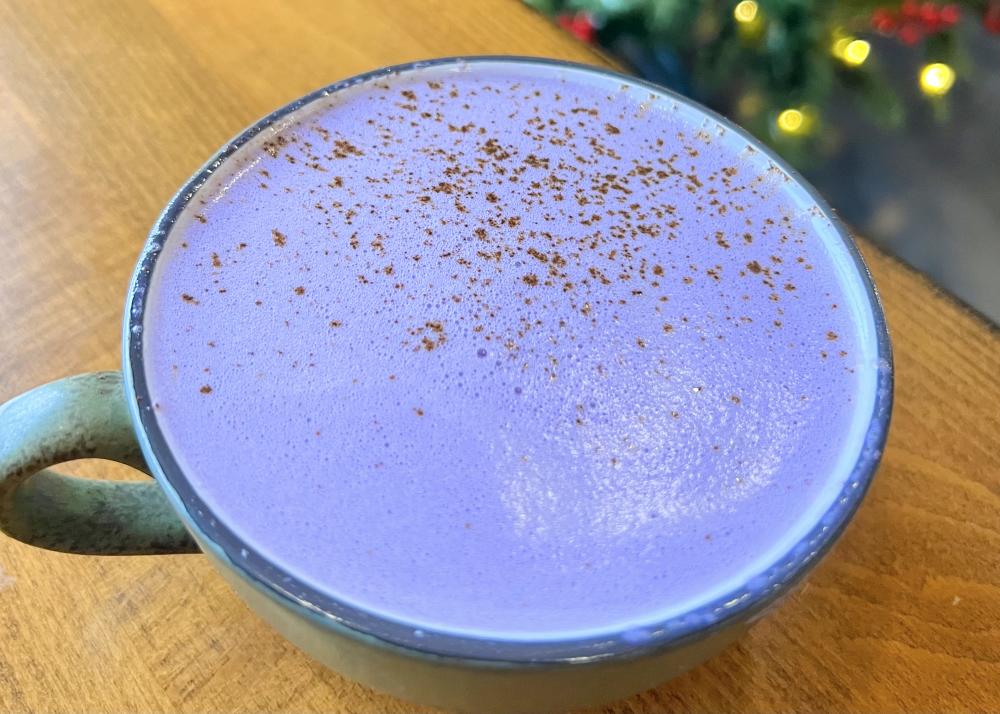 coffee mug filled with purple colored latte