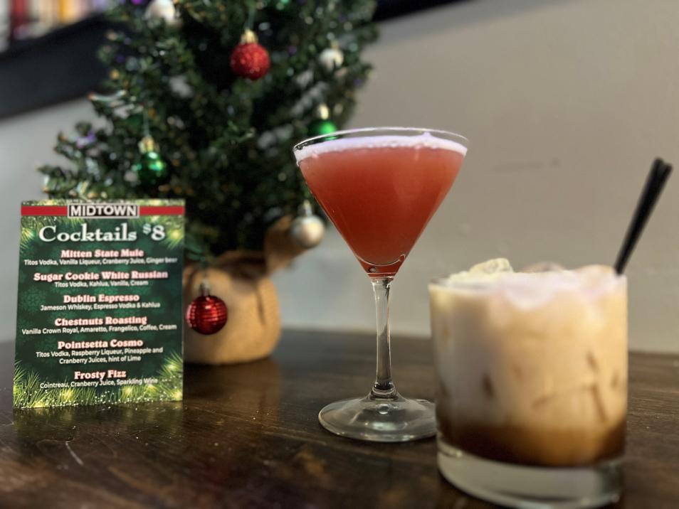 Two cocktails by a Christmas tree