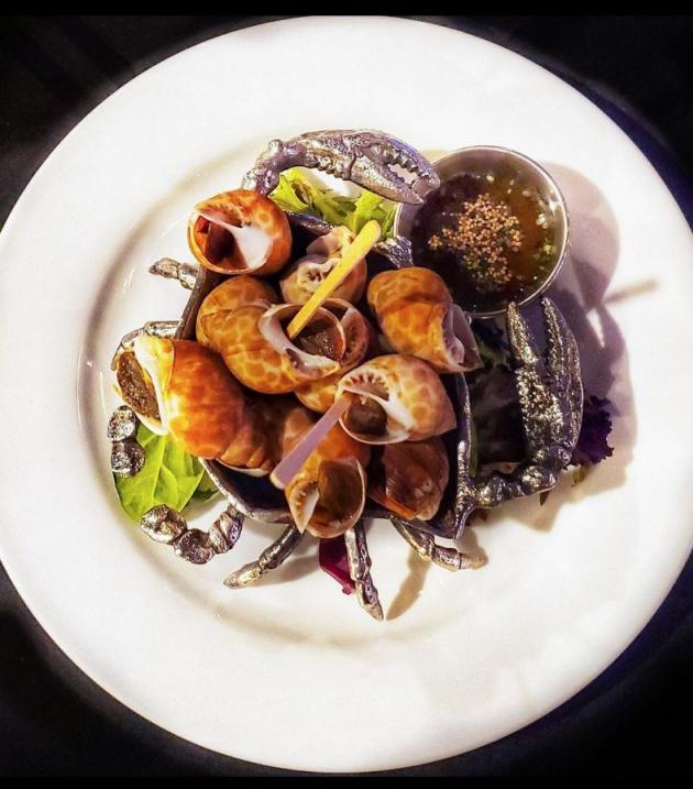 Plate of escargot and cup of sauce