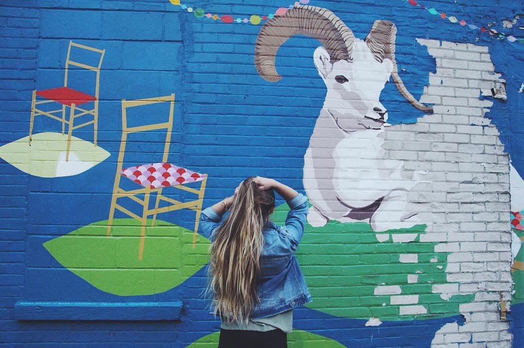 A woman admiring a mural