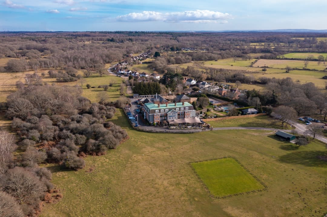 Drone shot of the exterior of Balmer Lawn Hotel and its surrounding forest