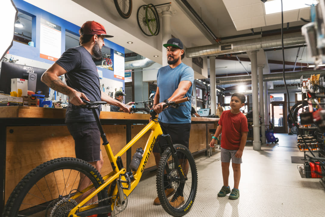 Inside Phat Tire bike shop with a yellow mountain bike at the counter.