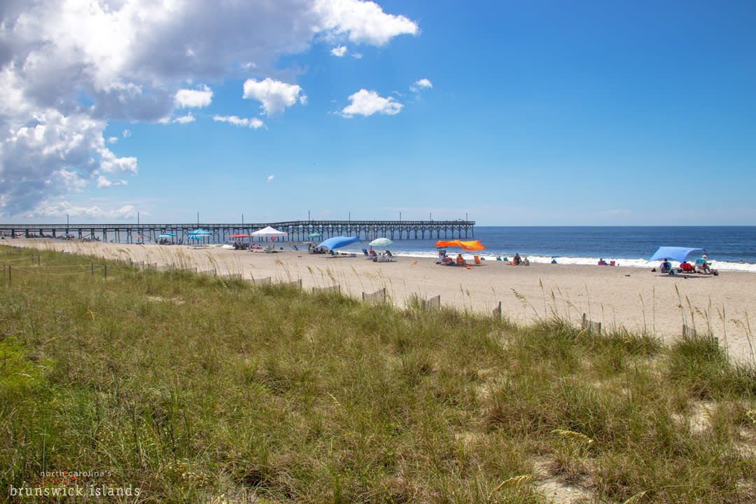View Of The Pier And Beach Umbrellas At Holden Beach