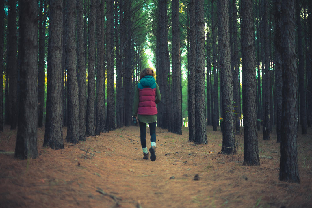 Woman walking through Bartram Forest near Milledgeville