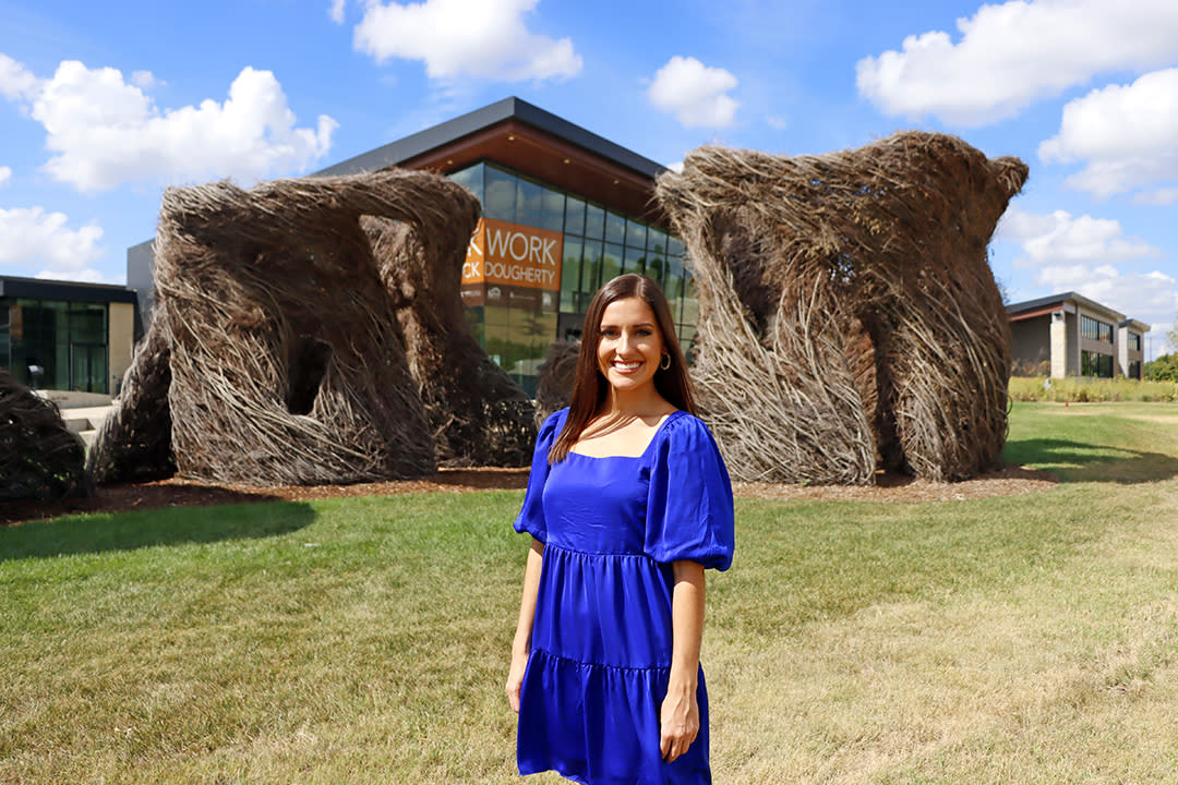 Miss Kansas 2022 stands in front of the Stickwork exhibit at Mark Arts