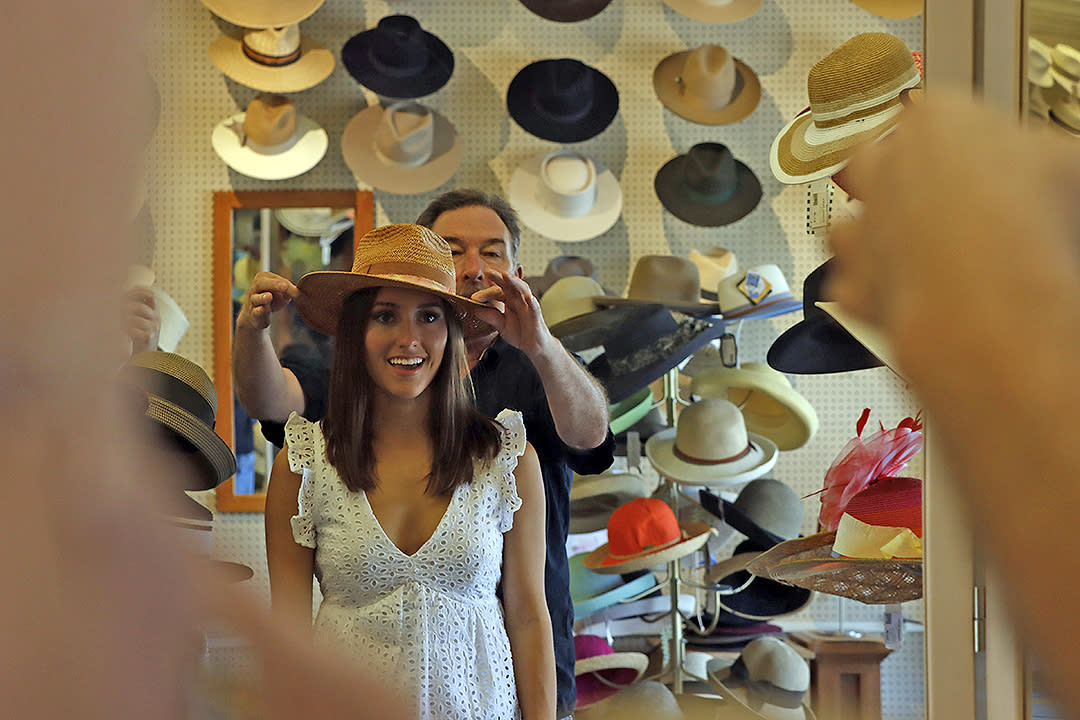 Jack Kellogg, owner of Hatman Jacks, puts a hat onto Miss Kansas