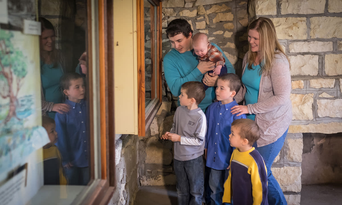 family looking at museum exhibit