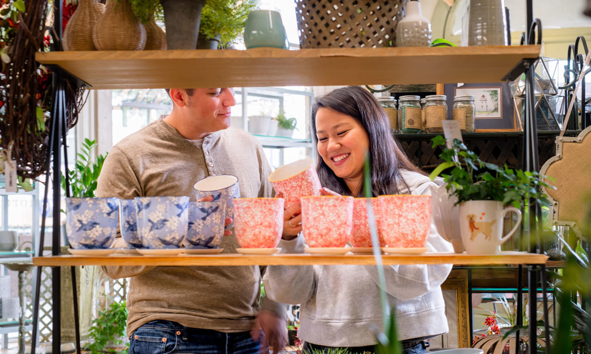 couple looking at colorful plant pots