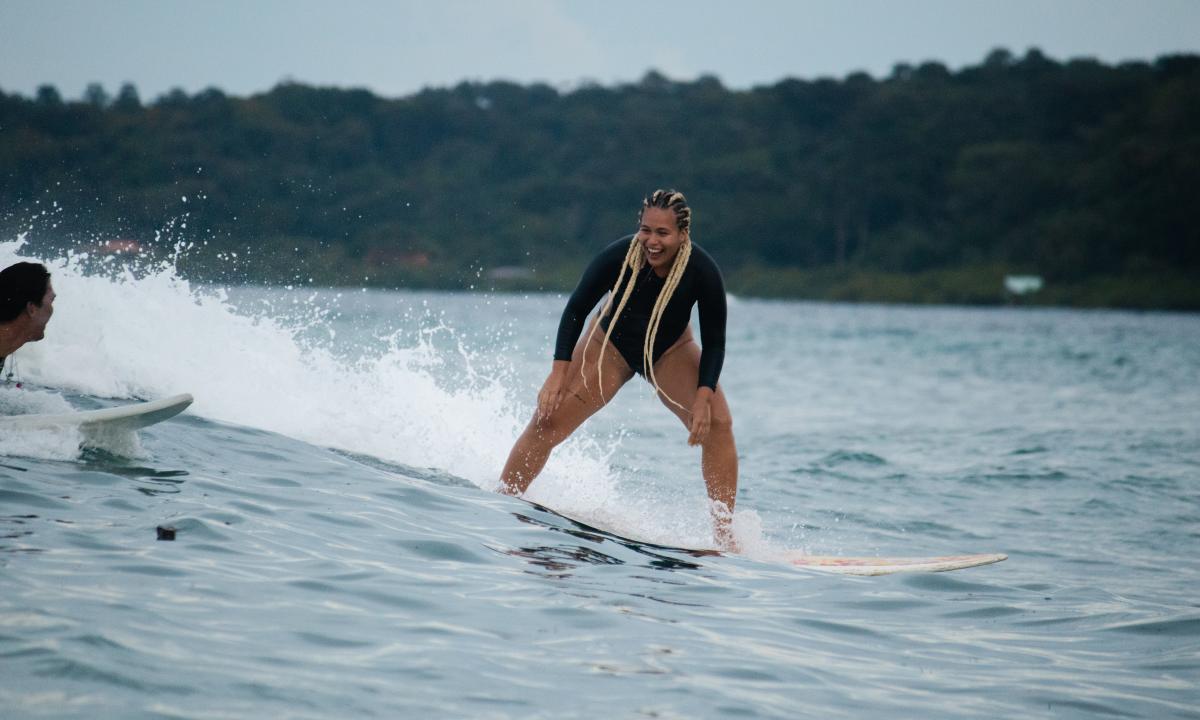Woman Surfing in Carenero Island