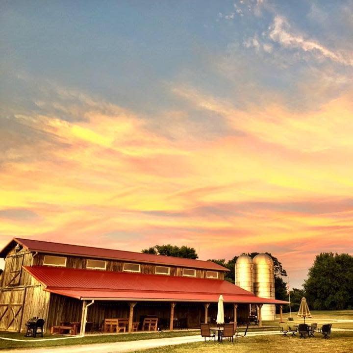 Image of the barn and silo's at the Verona Vineyard during the day.