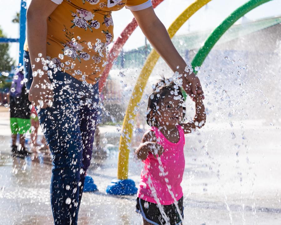 Mother and daughter walking through the O'Neil Park Splash Pad