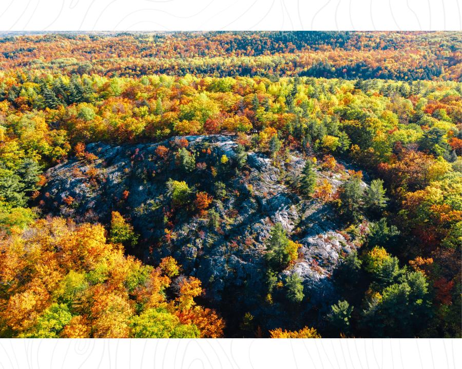 An aerial view of Mount Marquette surrounded by colorful fall foliage in Marquette, MI