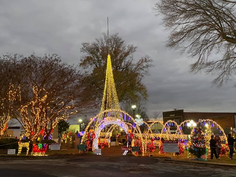 Various lights, including a yellow string light Christmas tree set up during Christmas on the Square in Moulton, AL
