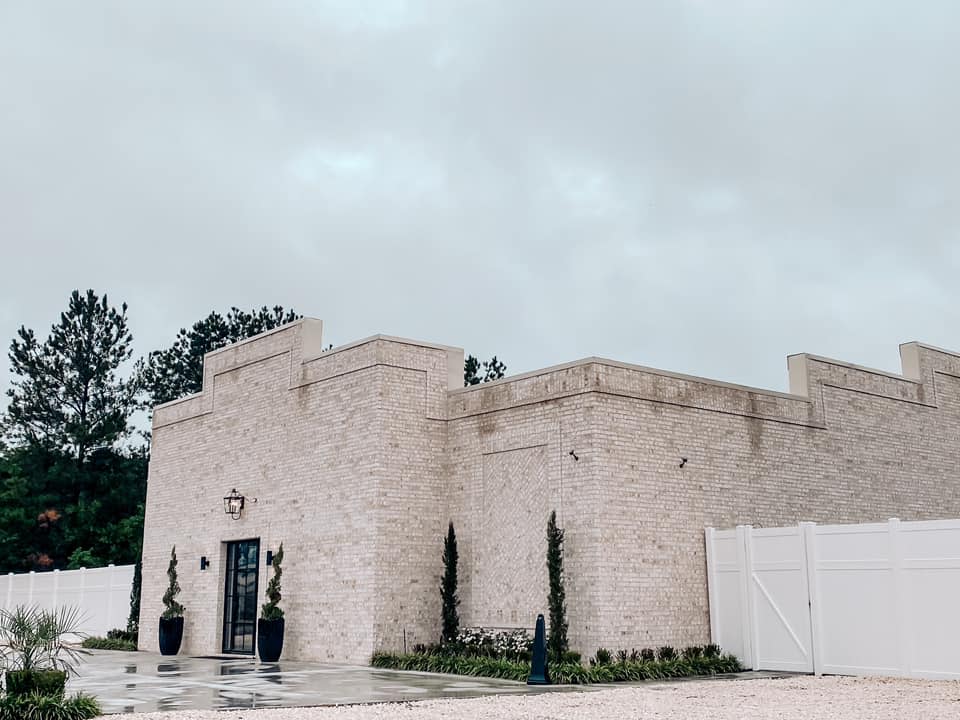 The main entrance at Reign Hills is stately with a white brick exterior.