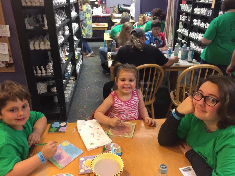 Kids coloring their clay at Clayfish Bisque