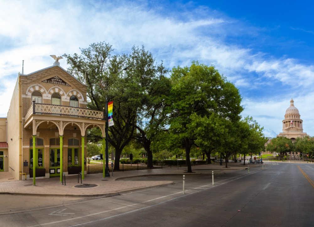 The exterior of the Old Bakery & Emporium on Congress Avenue with the Texas State Capitol building in the back.