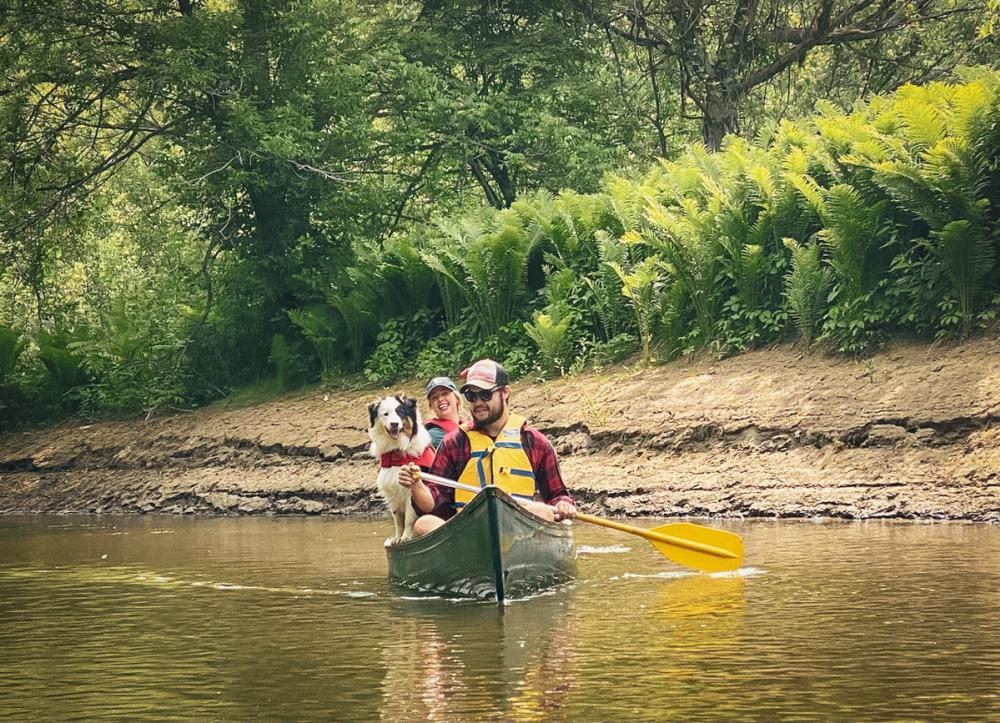 couple and dog in a canoe