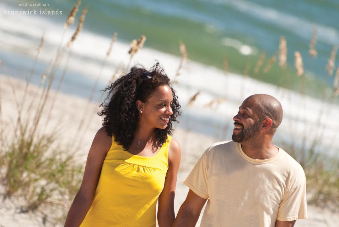 Couple walking on beach in North Carolina's Brunswick Islands