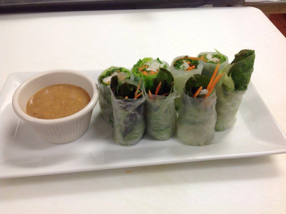 A white plate with a dish of sauce and vegetable rolls from 3 Ladies Thai in Florence, Ky.