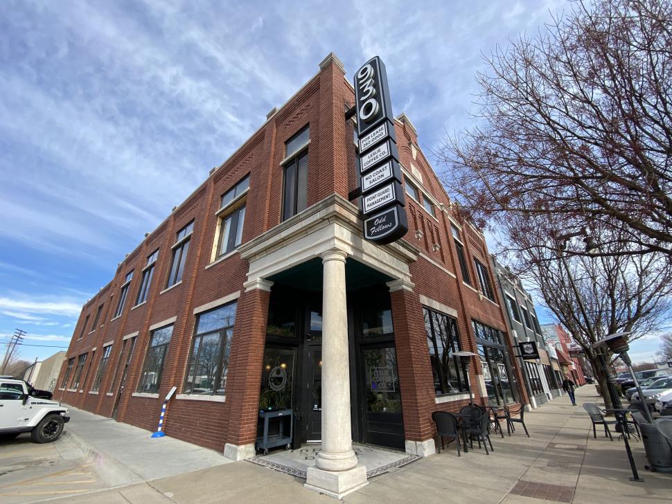 A large brick building - known as Odd Fellow Hall - with a vertical sign that reads "930"