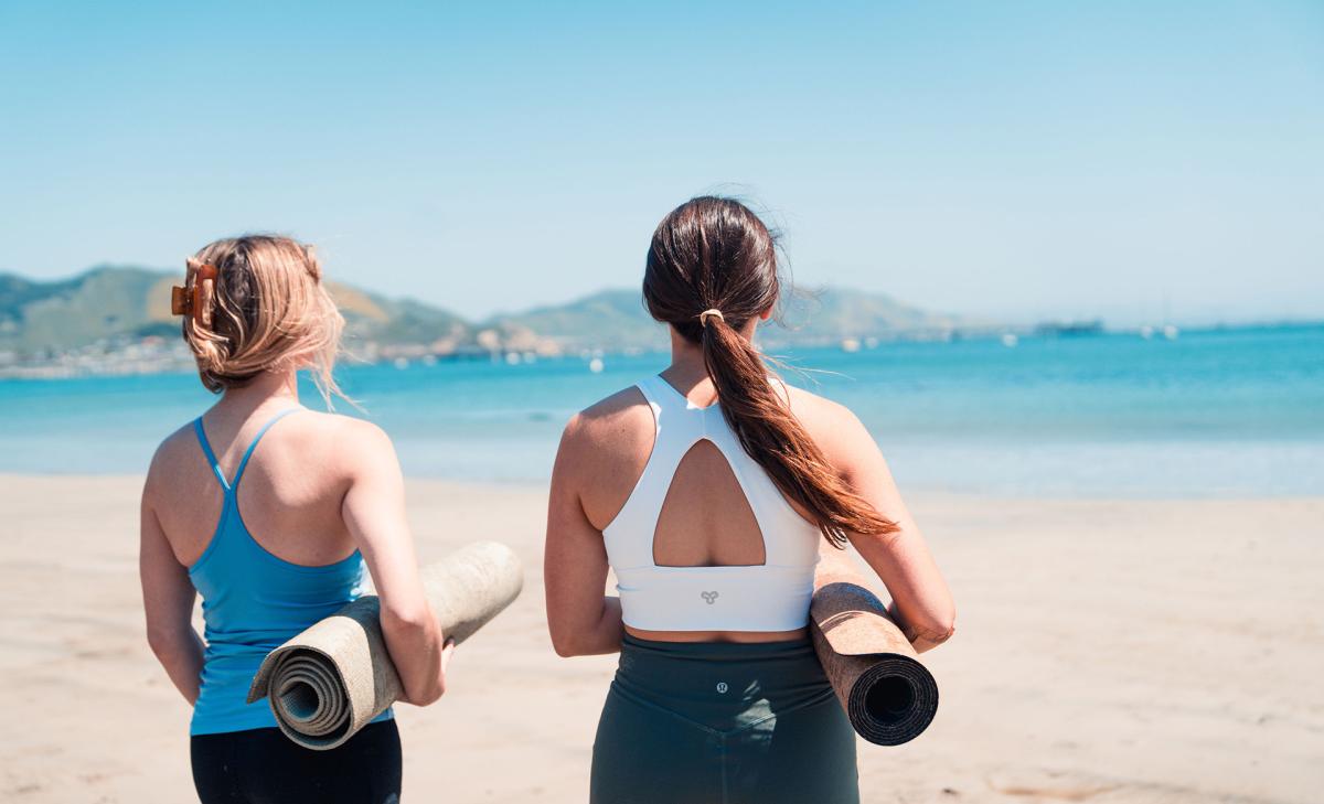 girls getting ready to do yoga on the beach in SLO CAL