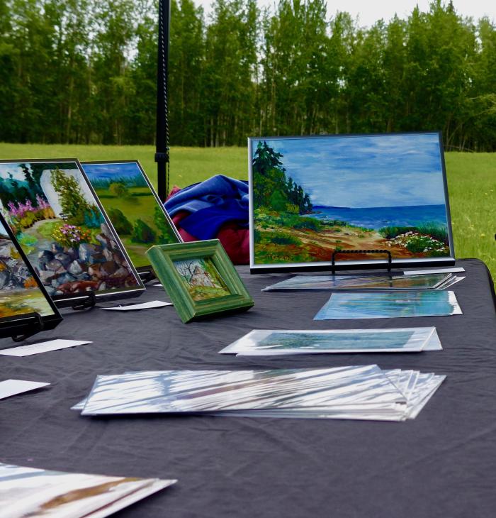 Landscape paintings on an event table in a green park