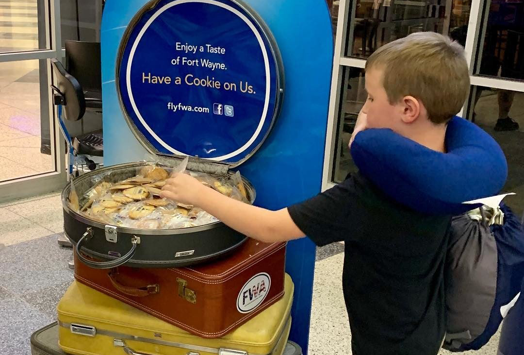 Child picking out a complimentary cookie at the Fort Wayne International Airport