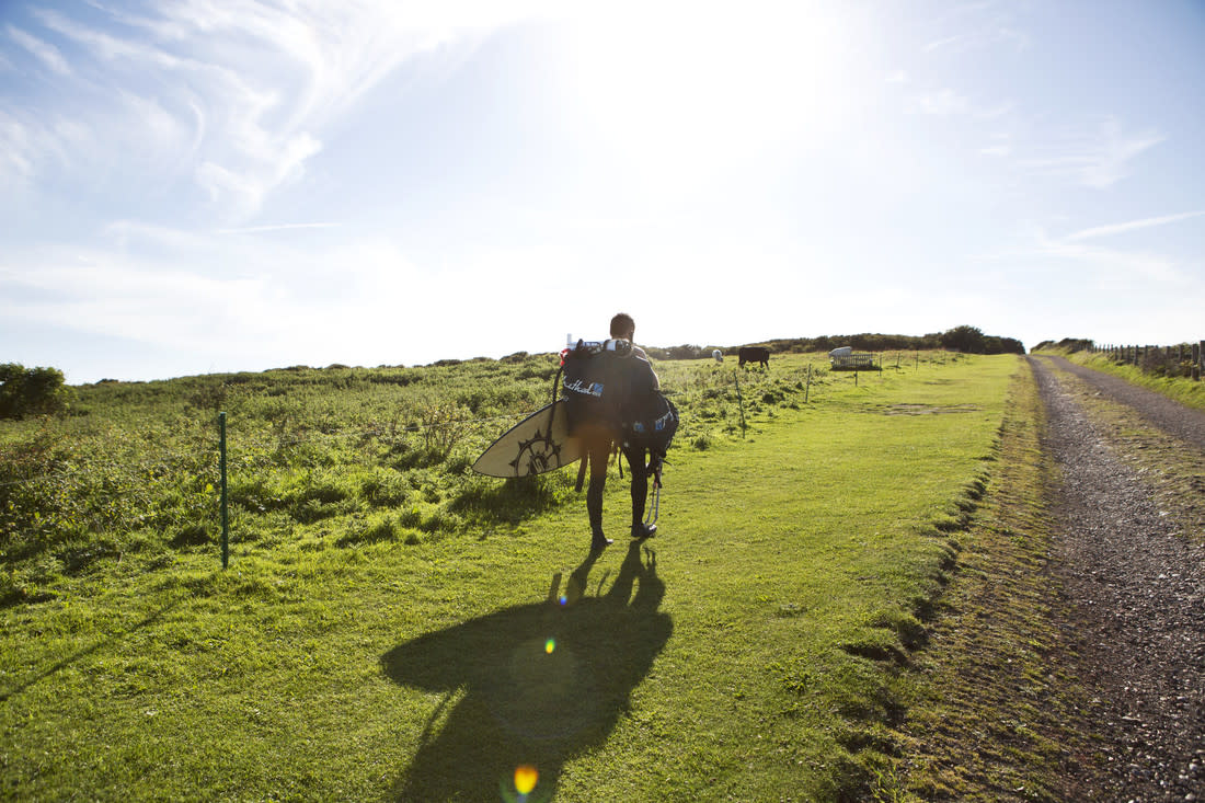 Man with surfboard on the South Downs Way