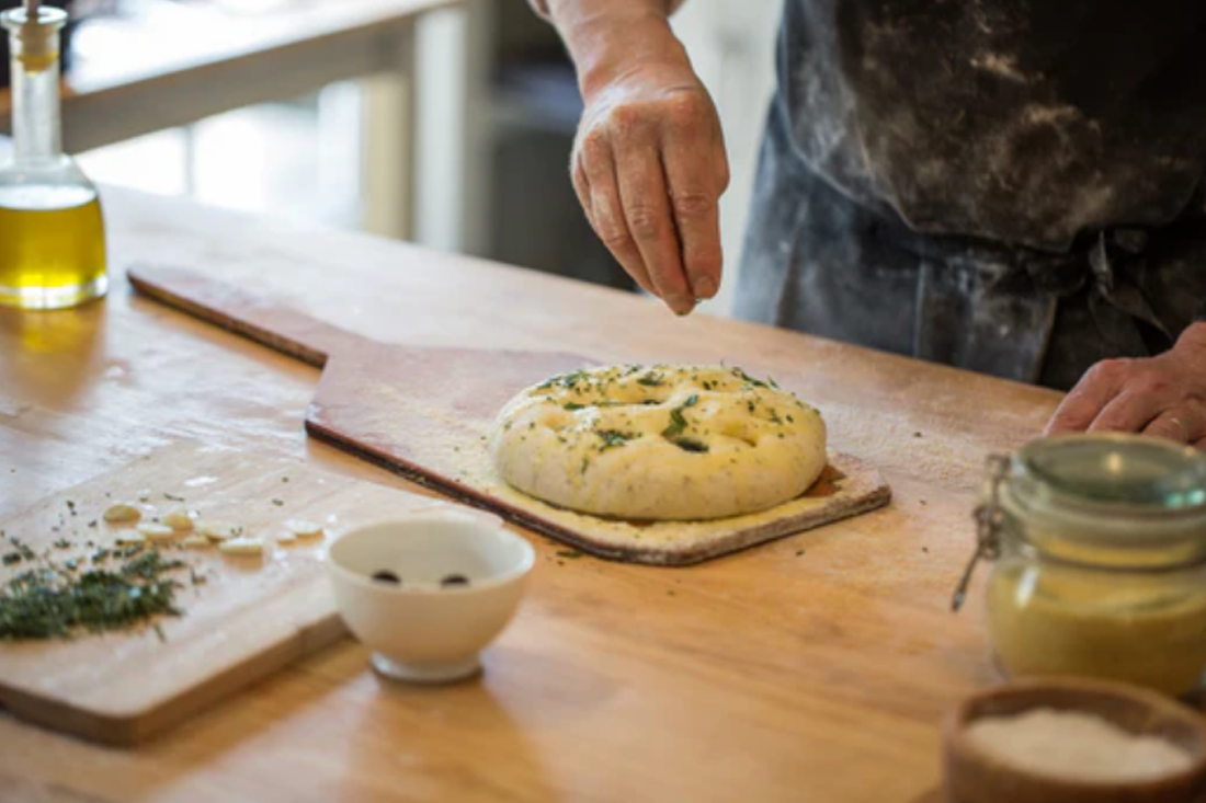 Person making bread at The Artisan Bakehouse