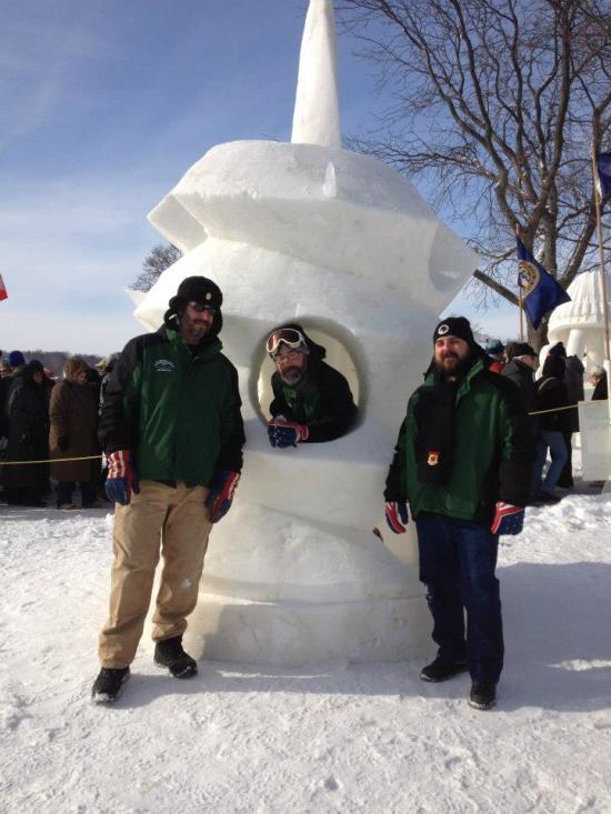 Picture of Team Vermont in front of a snow sculpture