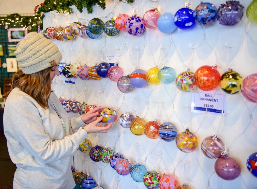 Woman looking at glass ornaments at Christkindlmarkt in Bethlehem, PA