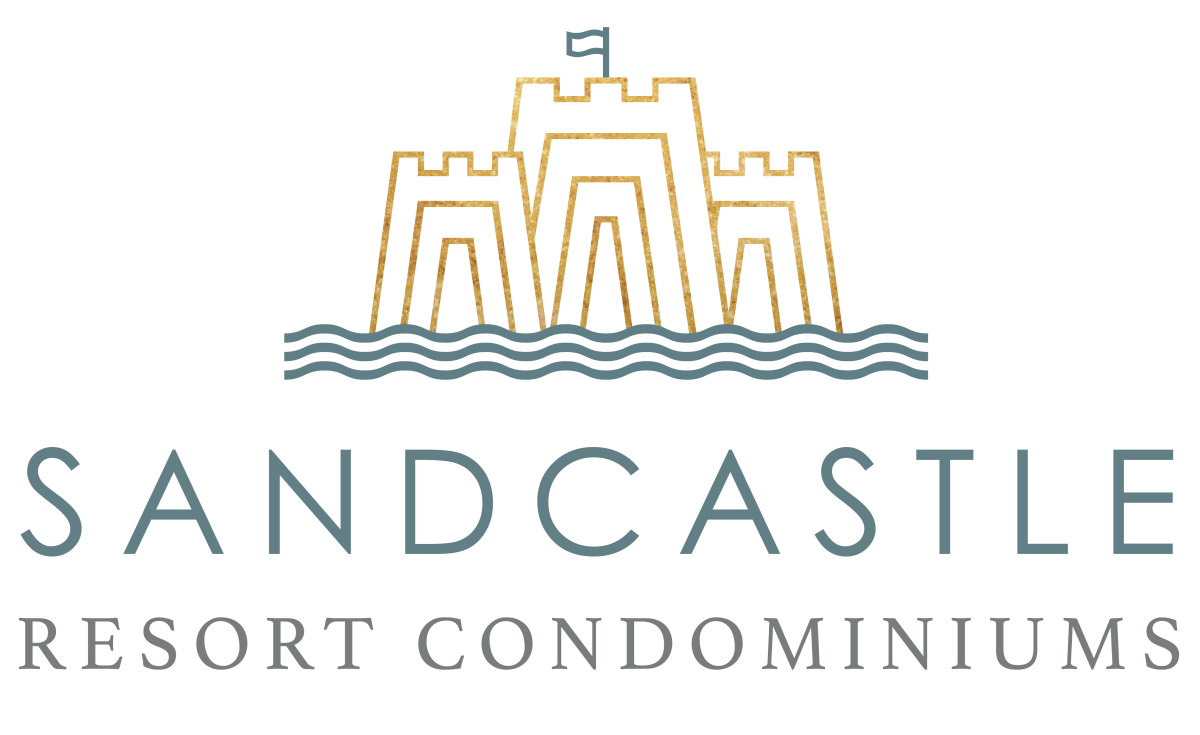 Line drawing of a sandcastle and some water in gold and teal. Under the drawing is a sans-serif font reading "Sandcastle" then under that a serif font reading "Resort Condominiums"