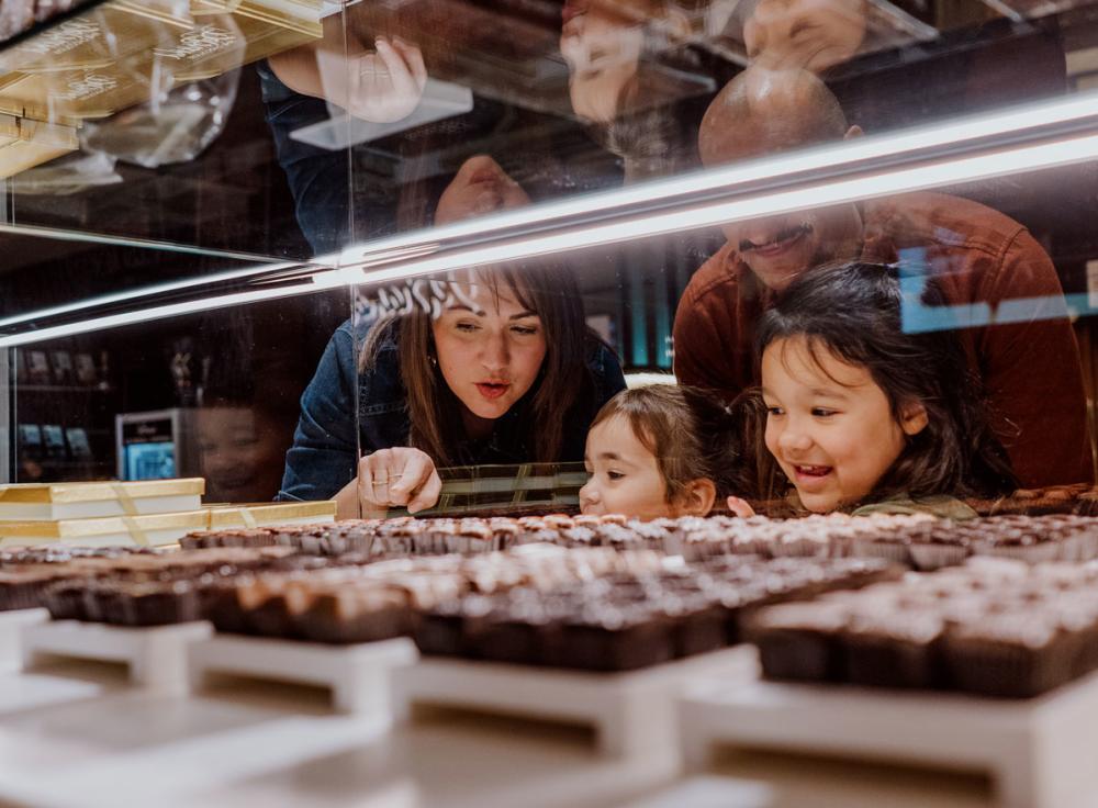 Little girls picking out chocolate at DeBrand Fine Chocolates