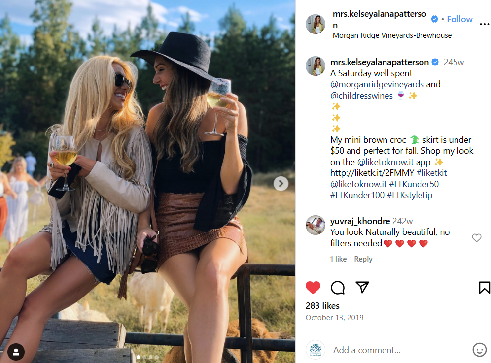 Two women drinking wine at a vineyard