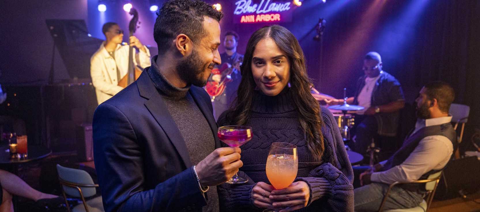 Couple holding drinks at Blue Llama Jazz Club