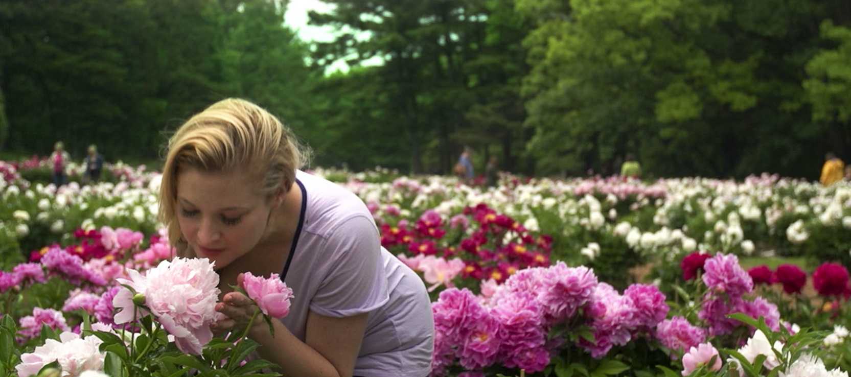 Woman smelling a peony