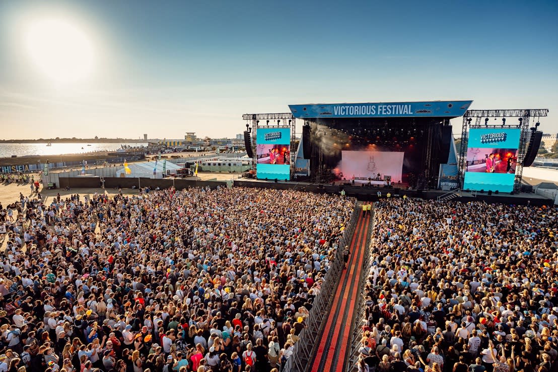 A Victorious Festival stage with a massive crowd in front of it. There is a performer on the stage.