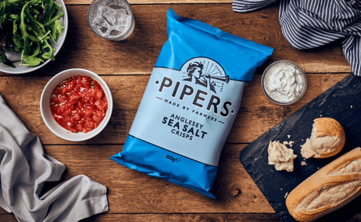 image of Pipers Crisps on a table next to various dressings and bread