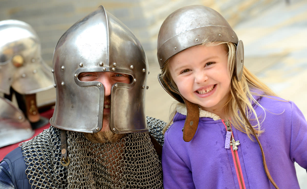 An image of a cosplaying medieval soldier and a young girl at Lincoln Museum
