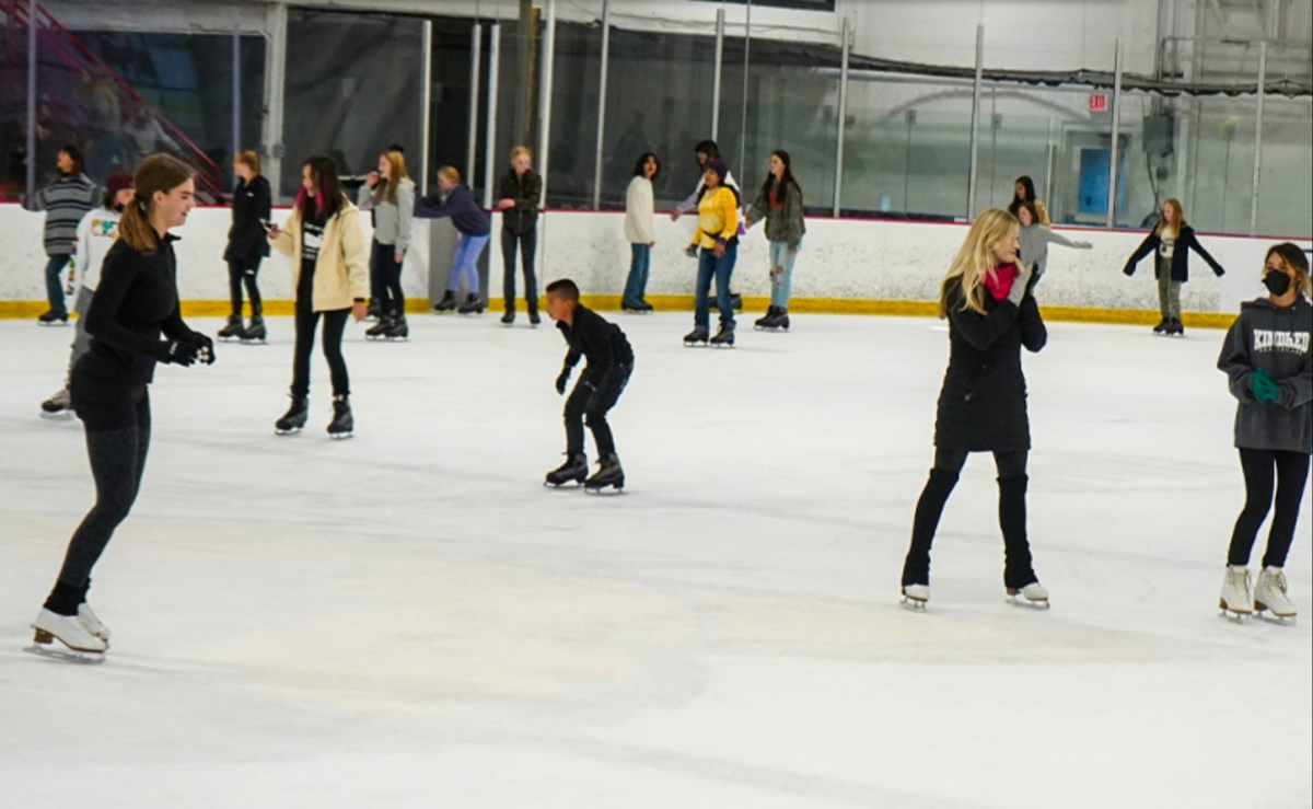Many people skate at Outpost Ice Arenas during a public skate session.