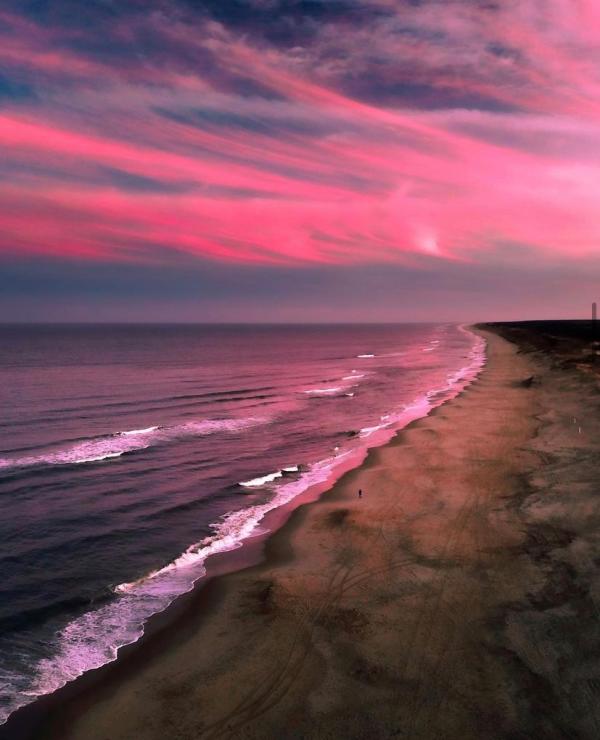 pink sunrise over the beach and shoreline