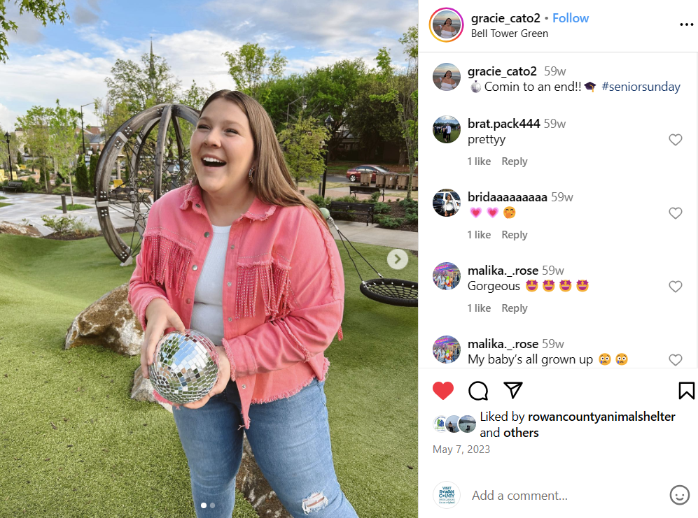 Young woman holding disco ball in park