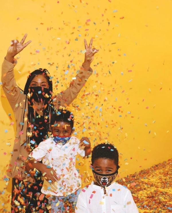 Confetti falls on a family at the Color Factory in Houston, TX