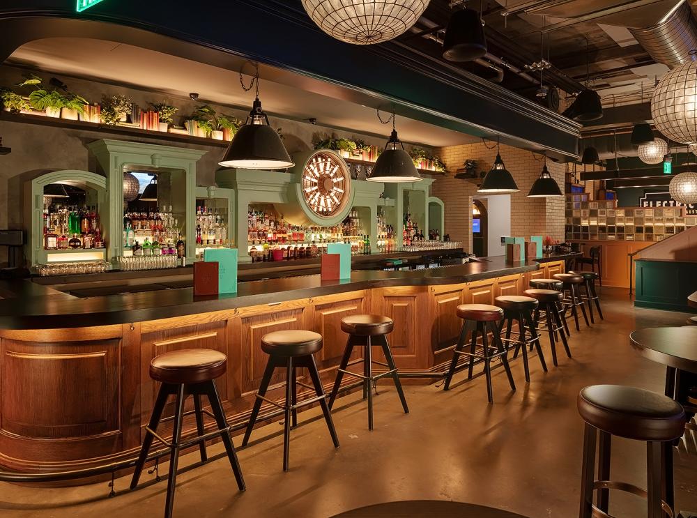 Retro bar at Electric Shuffle with warm decor and moody lighting.