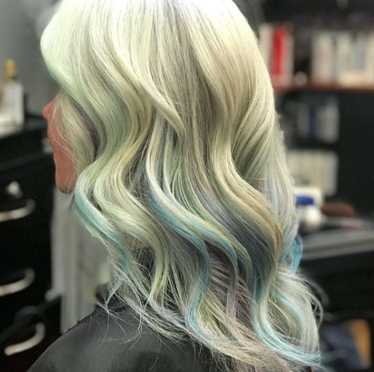 A woman poses with new blonde and blue hair