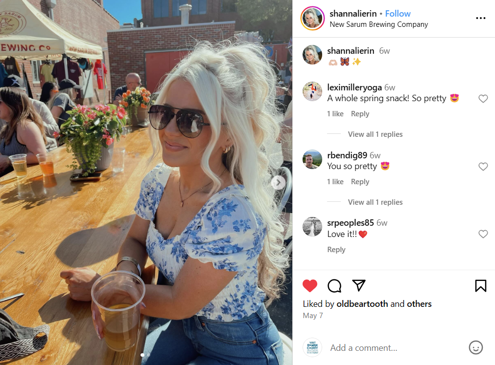 Woman outside drinking beer at a brewing company